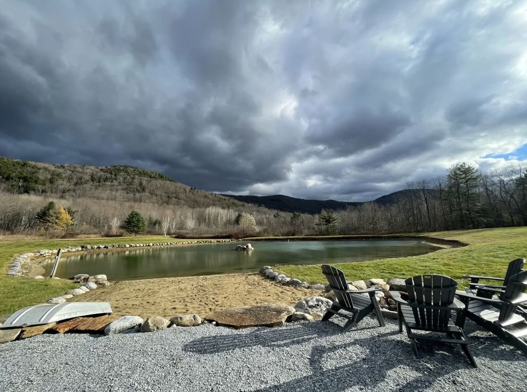 Storm clouds over the pond and mountains